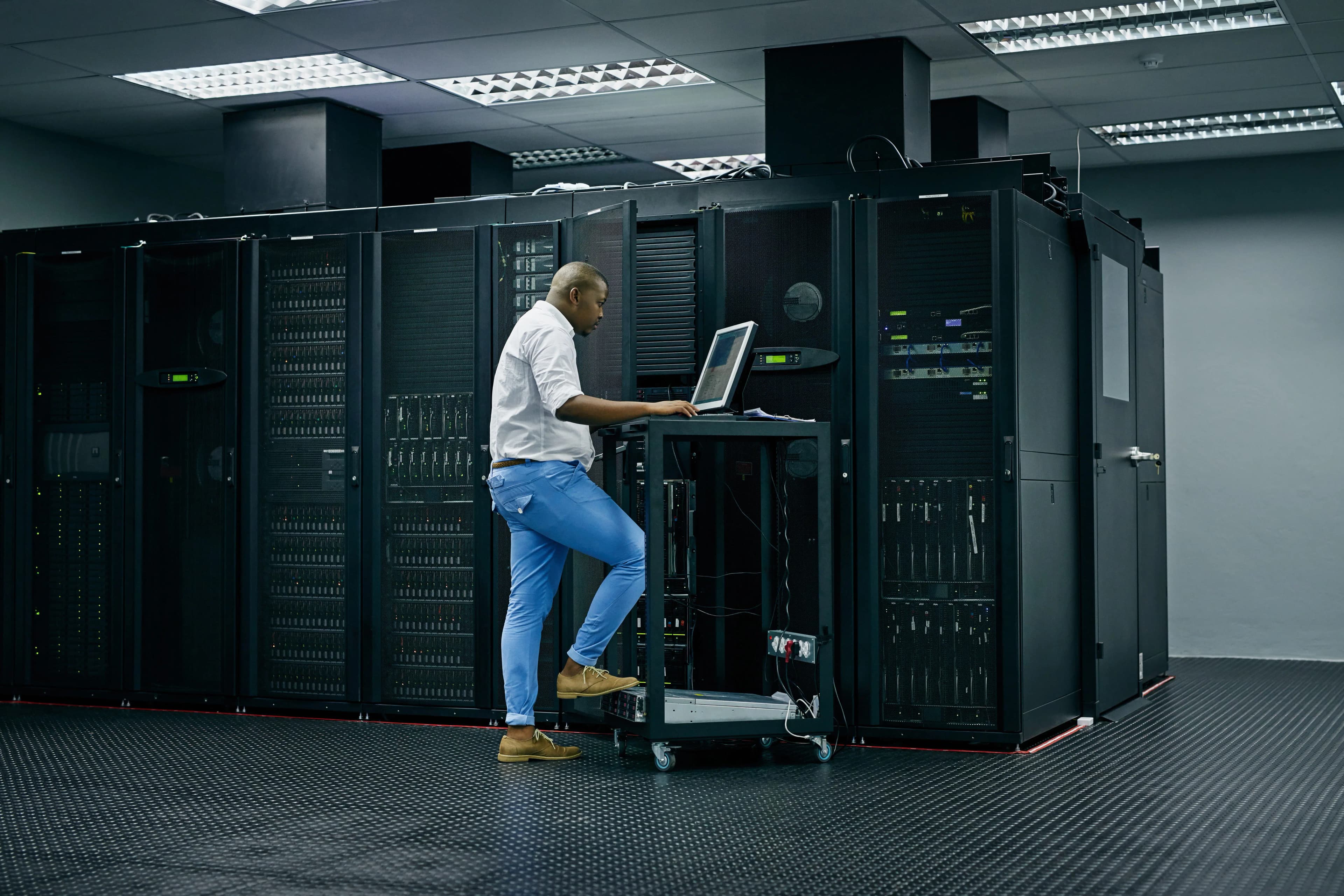 Data center technician working on storage servers console
