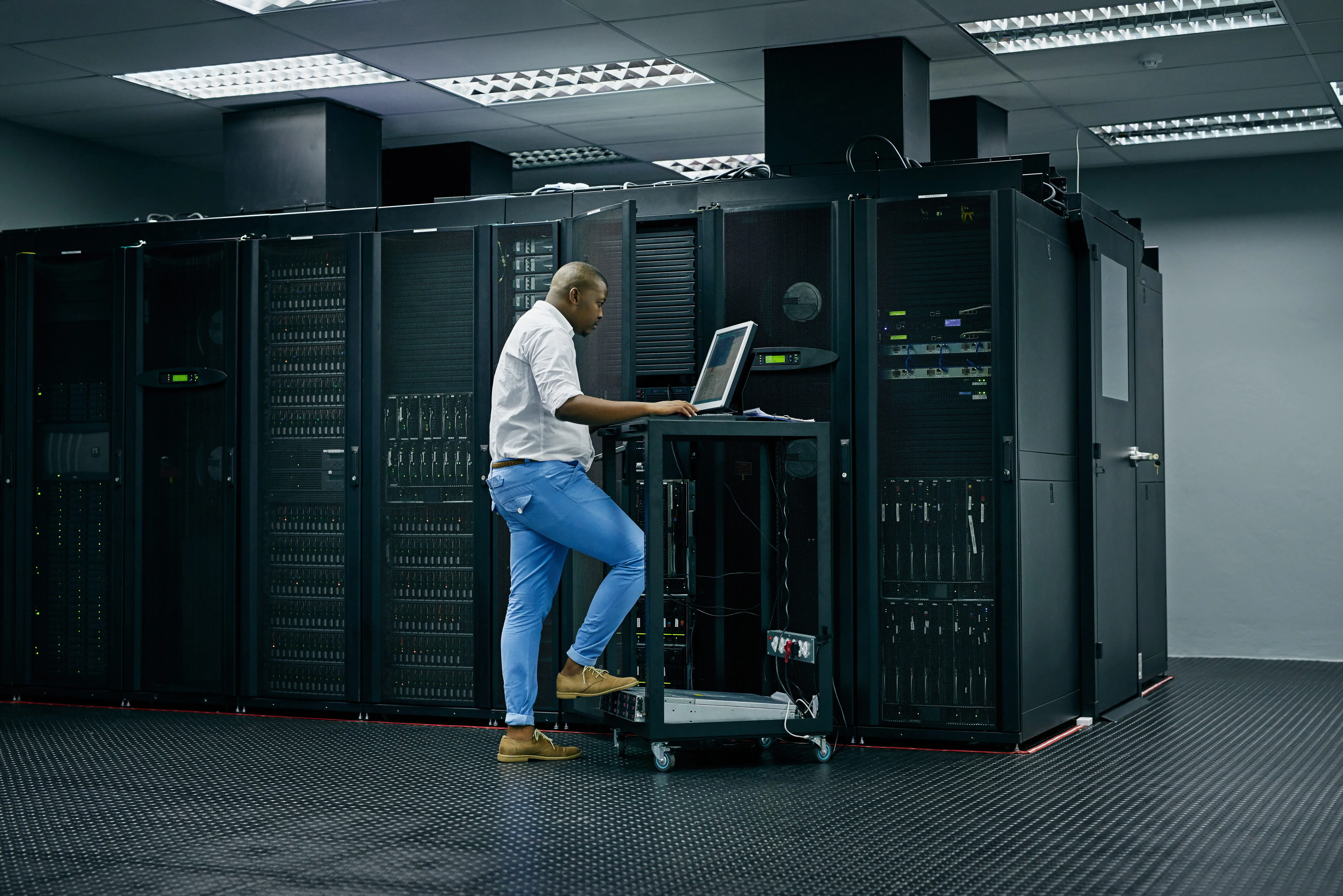 Data center technician working on storage servers console
